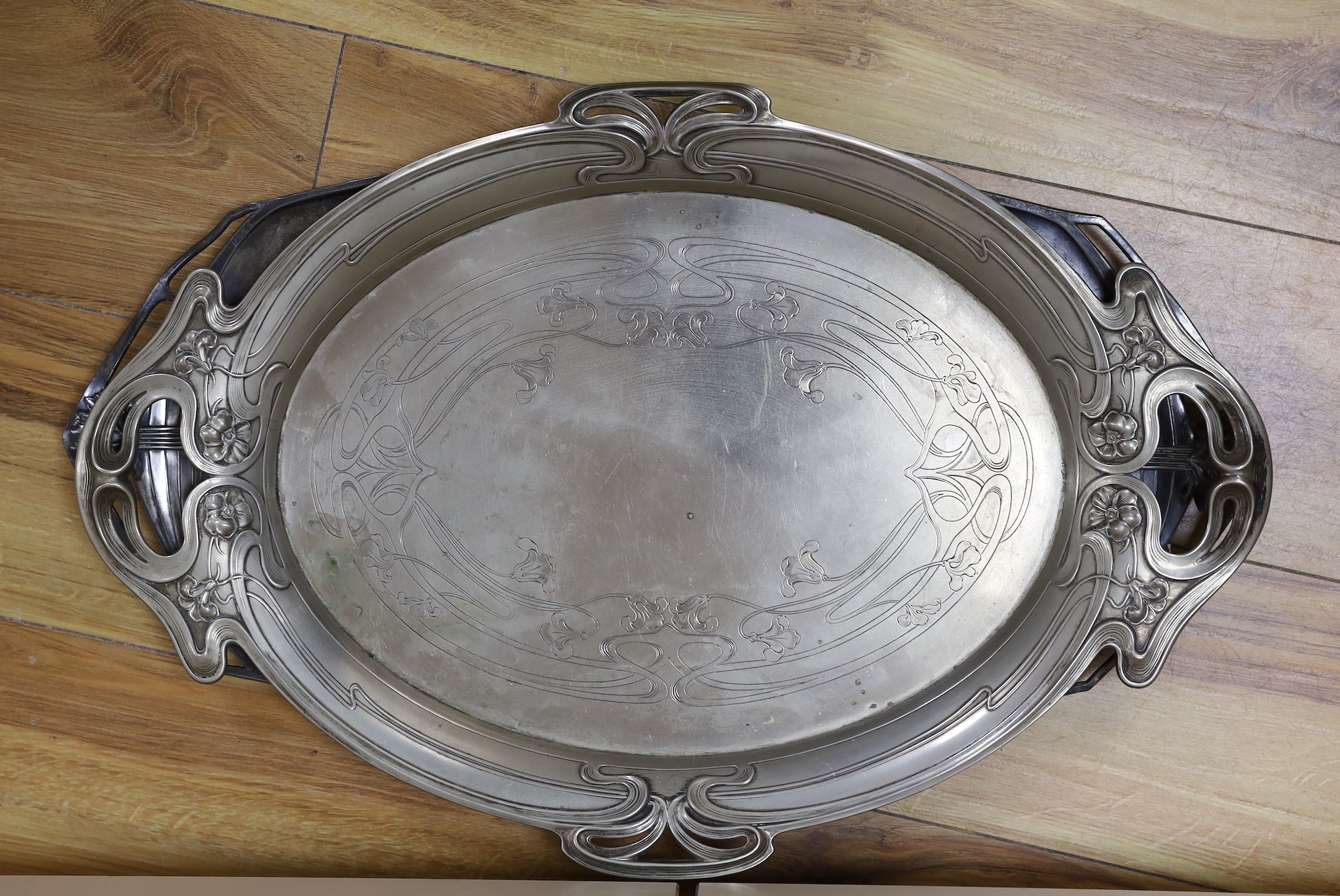 An Edwardian oval Art Nouveau metal tray, a similar oak and pewter tray and a WMF box, pewter tray 58 cms wide.